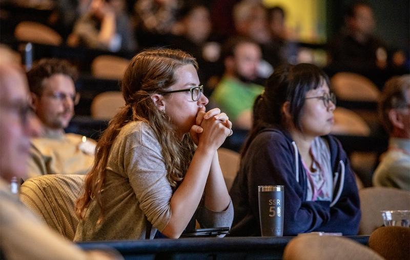 Event attendees listen to a science lecture